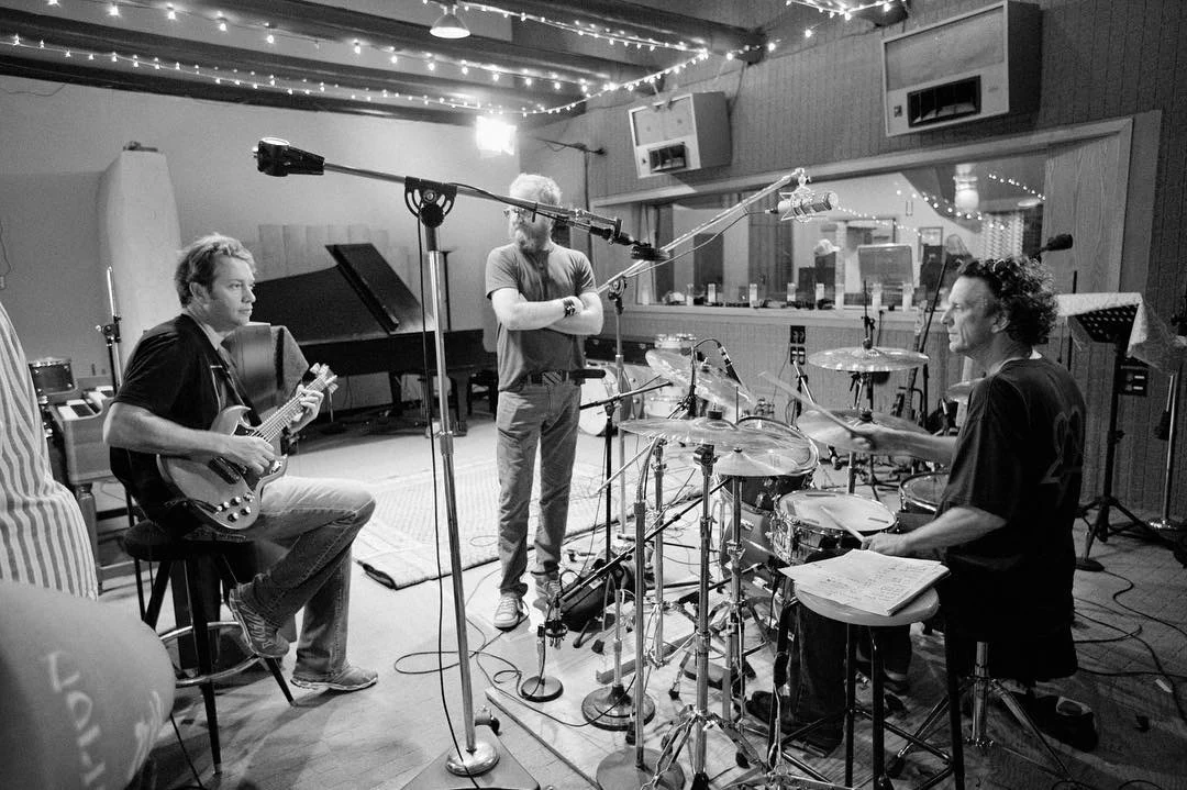 Musicians collaborating during a recording session